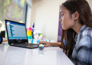 Young girl coding STEM robot with a laptop.