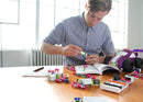 Educator reading instructions and putting littleBits invention together.