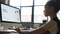 A female student works at her computer using an AI tool to assist in her project.