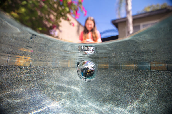 A girl drives her Sphero BOLT in a pool as part of a STEM Summer Camp activity.