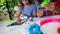 A girl and her mom work on STEAM-based activities with Sphero Mini Activity Kit at a table at home.