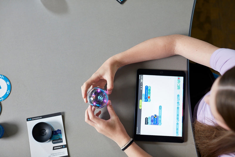 A student programs a BOLT+ robot in the Sphero Edu App on a tablet.