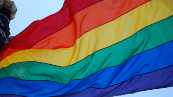LGBTQ rainbow pride flag flowing in the wind. 