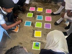 Students in Tanzania work on learning English and Chinese with Sphero indi in their classroom.