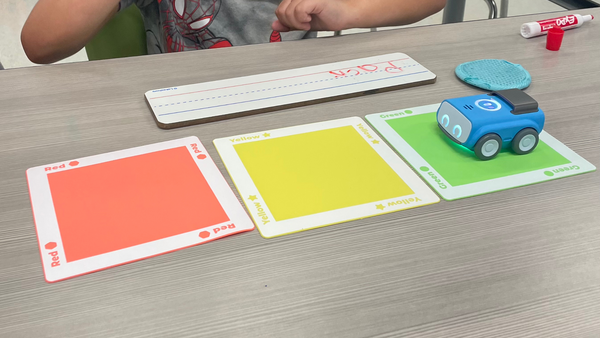 A student uses Sphero indi's color tiles to learn how to read.
