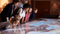 Students and teachers look at a large interactive map.