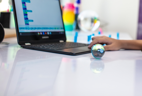 Student coding a robot with JavaScript.