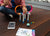 Student sitting on the floor with Iphone and Sphero mini, putting together a STEAM mini activity kit