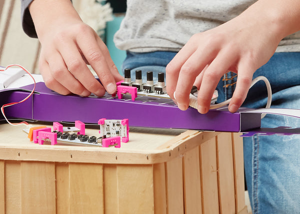 Kid learning STEAM and making a keytar.