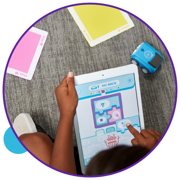 Young boy coding Sphero indi computational thinking robot.