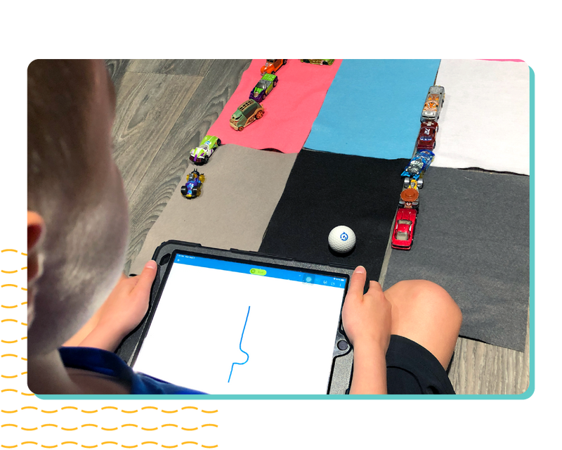 Mini Soccer next to hand coding on an iphone.
