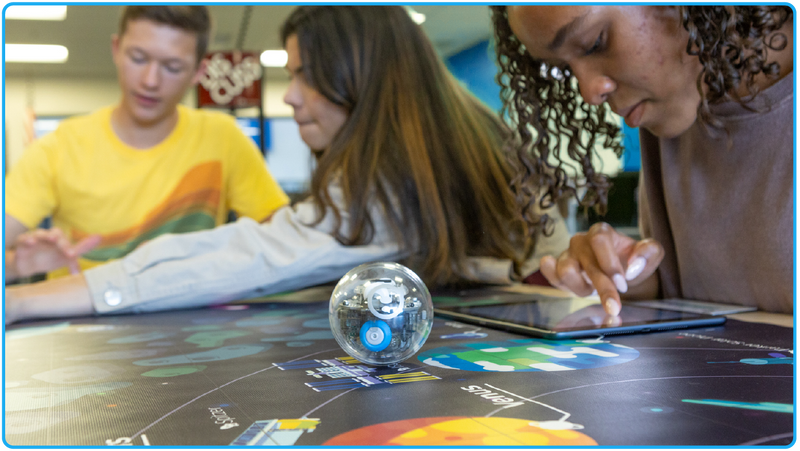 Student with coding robot doing a space activity. 