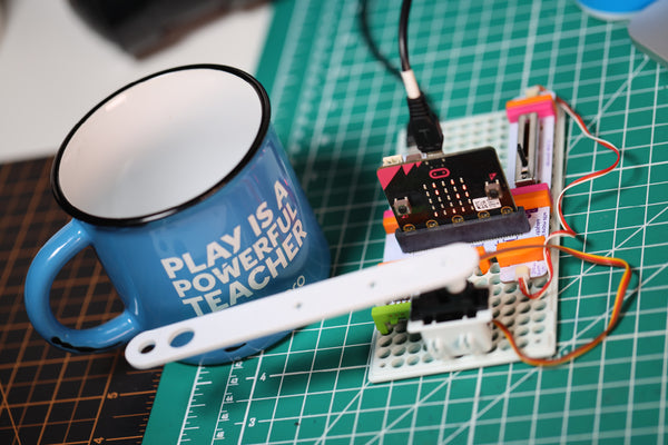 micro:bit Adapter invention with mechanical arm tapping a coffee mug.