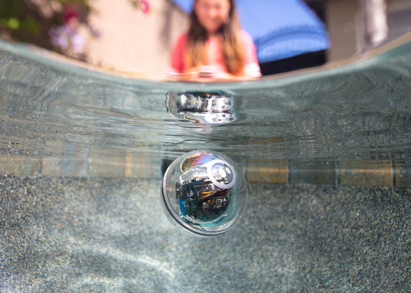 Girl using a waterproof coding robot for kids.