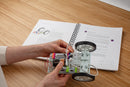 Teacher using guide to build a car invention out of littleBits circuits. 
