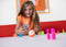 Girl playing with Sphero Mini™ Pins & Cones Accessory Pack with her robot toy.