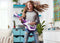 Girl dancing in room with littleBits guitar.