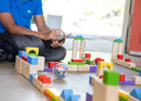 Young child programming STEAM robot through block maze.