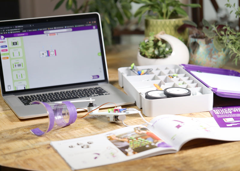 Laptop showing circuit simulator next to littleBits invention, tackle box, and invention guide.