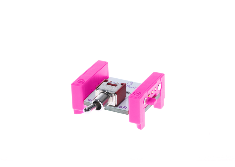 Pink littleBits i2 toggle switch bit side view.