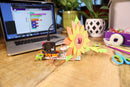 Sunflower micro:bit invention with craft supplies and laptop in the background.