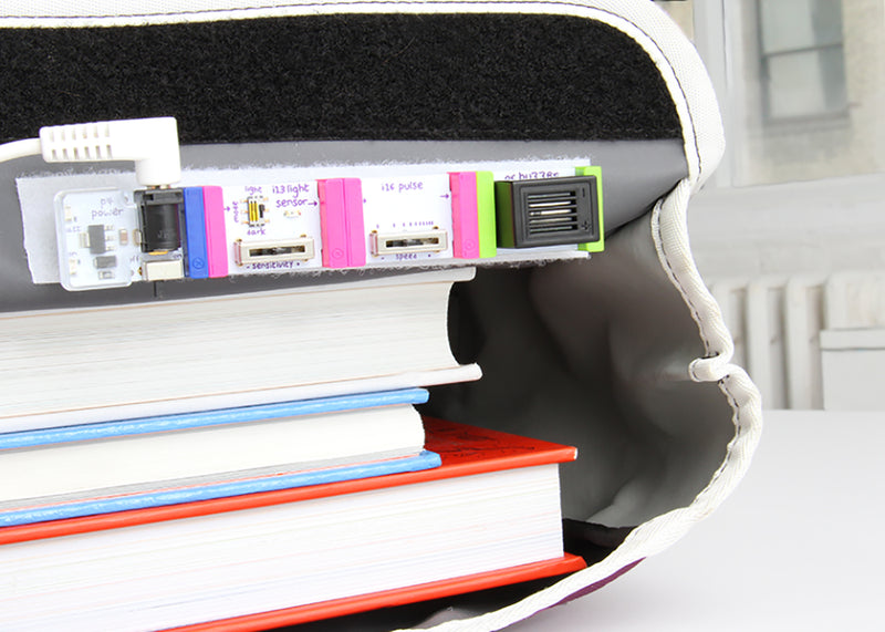 Bit from littleBits STEAM Student Set peeking out from backpack.